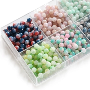 Close-up of 10mm frosted ice crack glass beads in a clear multi-grid storage box