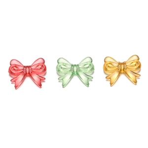Close-up of translucent acrylic bow beads in pink, green, and amber for DIY crafts