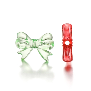 Detail of colorful acrylic bow beads with central threading hole for DIY jewelry