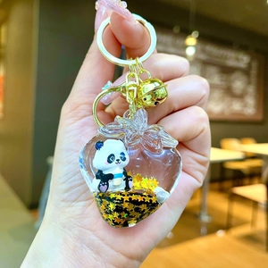 Cute panda charm in strawberry shaped liquid keychain with yellow sequins and a bell