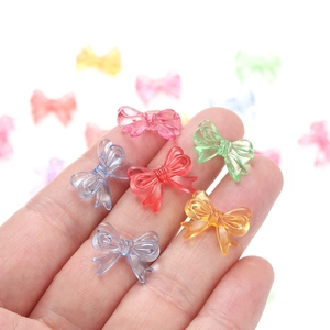 Close-up of translucent candy-colored acrylic bow beads for DIY jewelry making