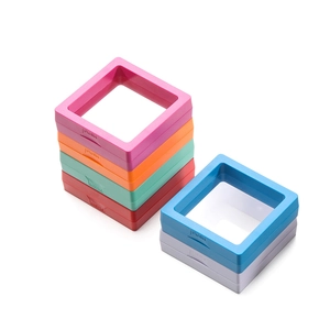 Macro detail of colorful PE film floating jewelry boxes with PUSH button opening design