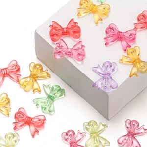 Close-up of colorful translucent acrylic bow beads in assorted macaron colors for DIY