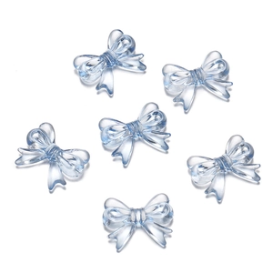 Macro shot of six light blue translucent acrylic bow beads for DIY craft making
