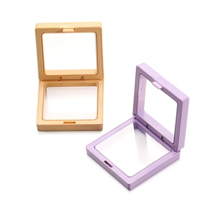Close-up of square PE film jewelry boxes in light orange and purple with push button