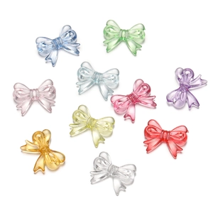 Flat lay of colorful transparent acrylic bow charms for DIY jewelry and phone chains
