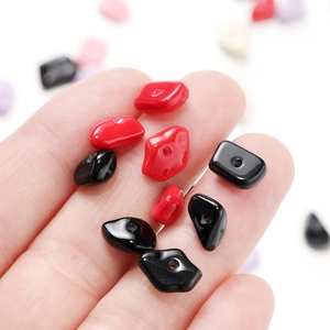 Handheld display of colorful irregular acrylic beads with glossy finish for DIY jewelry
