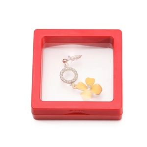 Detail of floral earring with crystals displayed in a red 3D floating film jewelry box