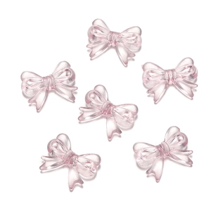 Macro detail of six translucent pink acrylic bow beads for DIY jewelry and phone chains