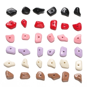 Macro shot of assorted colorful irregular acrylic beads with holes for DIY jewelry