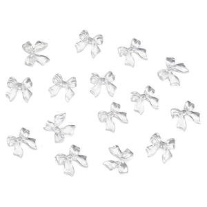 Flat lay of transparent resin bow charms for nail art and DIY craft accessories