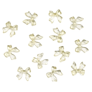 Close-up of translucent light yellow resin bow accessories for DIY nail art designs
