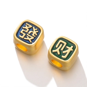 Macro view of gold-plated square beads with blue and green enamel and Chinese characters