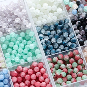 Macro shot of 10mm frosted ice-cracked glass beads in a grid storage organizer box
