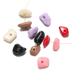 Macro shot of colorful irregular acrylic beads with smooth glaze finish for DIY jewelry