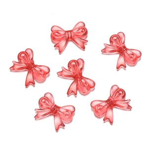 Detailed view of 6-piece transparent acrylic butterfly bow beads with polished pink finish