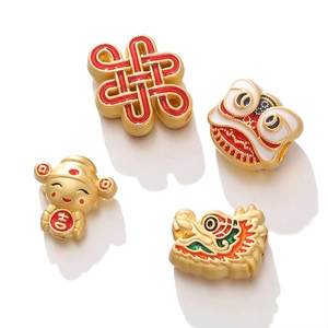 Detailed macro of gold-plated alloy beads with traditional Chinese lion and fortune motifs