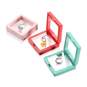 Detailed view of colorful PE film floating display boxes in pink, red, and mint green colors