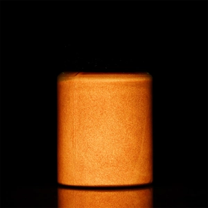 Detailed view of long-lasting orange luminous powder in a 20g jar with reflection