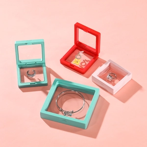 Macro detail of multi-colored PE film floating jewelry display boxes on pink background