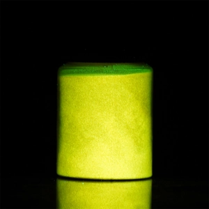 Macro shot of 20g jar showing intense glow-in-the-dark fluorescent green luminous powder