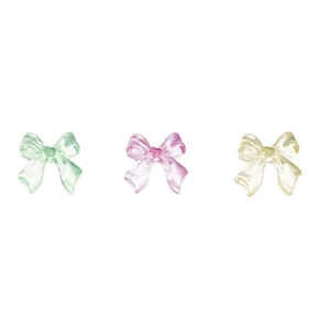Detailed view of 3D resin bow charms in translucent mint green, pink, and yellow shades