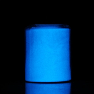 Macro shot of 20g high-glow luminous blue powder in a sealed jar on a dark background