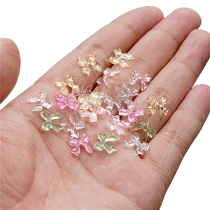 Close-up of colorful translucent resin bow charms for nail art and DIY decoration