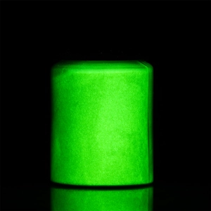 Luminous powder jar glowing bright green against a black background for dark effects