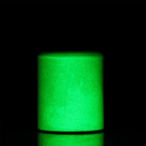 Detail of glow-in-the-dark luminous powder showing intense green fluorescence in dark