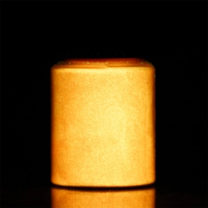 Macro shot of 20g jar showing intense orange luminous powder glowing in the dark