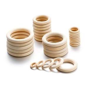 Detailed view of various sizes of natural smooth wooden rings for DIY crafts and decor