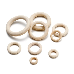 Various sizes of natural wood rings on white background for DIY craft and bag handles