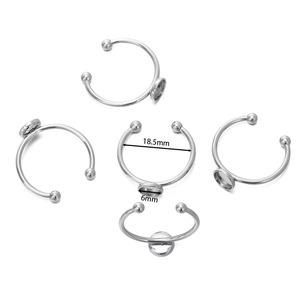 Detailed view of silver stainless steel adjustable ring blanks with 6mm DIY setting trays