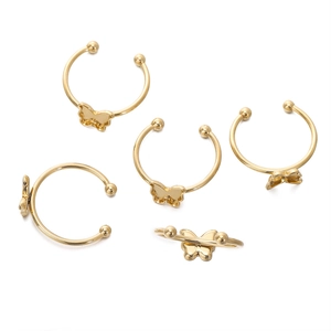 Detail of five 18k gold plated butterfly ear cuffs with smooth polished metal finish
