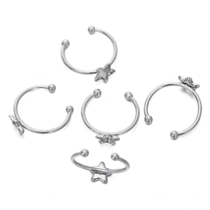 Detailed view of five silver star-shaped open rings with polished ball ends and mirror finish