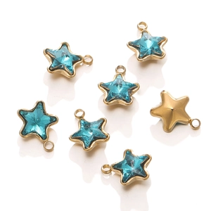 Detail of star-shaped pendants with 18k gold plating and blue crystals for DIY jewelry