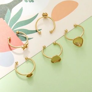 Close-up of 18k gold-plated heart and star-shaped ring base settings for DIY jewelry