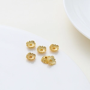 Detailed macro of 18k gold plated hollow flower bead caps for DIY jewelry making