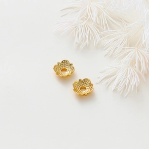 Detailed macro view of 18k gold plated hollow flower petal spacers for DIY jewelry making