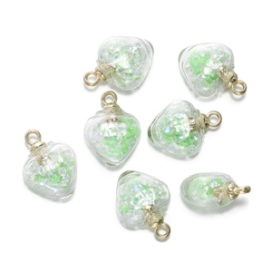Vue détaillée de pendentifs cœur en verre avec pierres vertes et attaches dorées