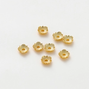 Detailed view of eight 18k gold-plated flower bead caps with hammered texture