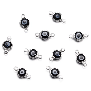 Macro shot of silver stainless steel evil eye connector pendants for DIY jewelry making