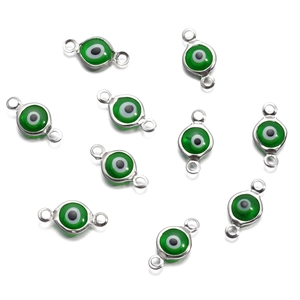 Detailed macro view of 10 green evil eye connector charms for DIY jewelry making