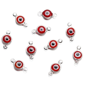 Macro detail of 10 red round evil eye connectors in stainless steel for DIY jewelry