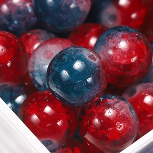 Macro detail of 10mm red and blue crackle glass beads for DIY jewelry making and crafts