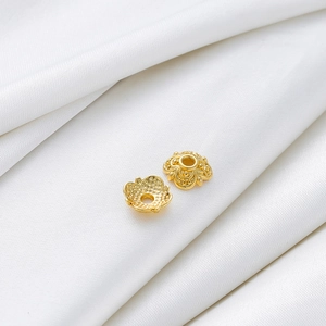 Macro shot of 18k gold plated hollow flower petal bead caps for DIY jewelry making