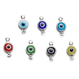 Macro view of stainless steel evil eye connectors in seven vibrant colors for DIY jewelry