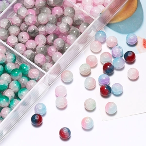 Macro view of 10mm cracked glass beads with two-tone gradient colors in a storage box