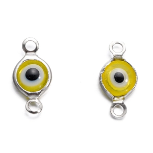 Macro view of yellow evil eye connector charm with silver double rings for DIY jewelry making